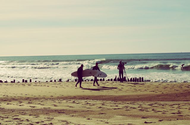 Two surfers riding a small wave together.