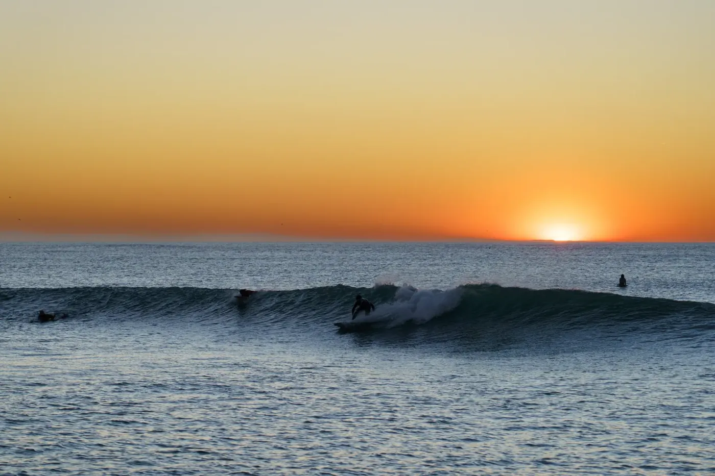 Surfeur sur une vague au coucher du soleil à la plage du Santocha à Capbreton